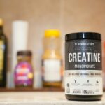 Creatine monohydrate from Jacked Factory displayed on a kitchen counter.
