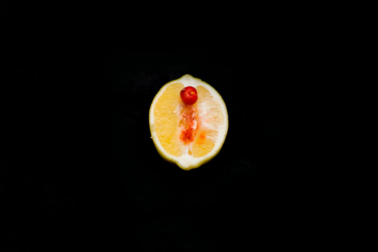 Artistic depiction of a fruit slice with a cherry atop, symbolizing concepts in a studio setting.